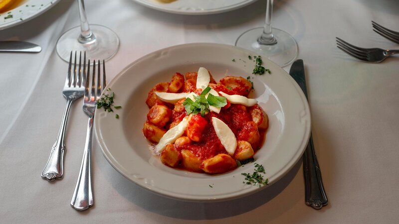 Gnocchi entree topped with marinara and cheese